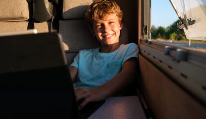 Delighted boy browsing netbook in RV